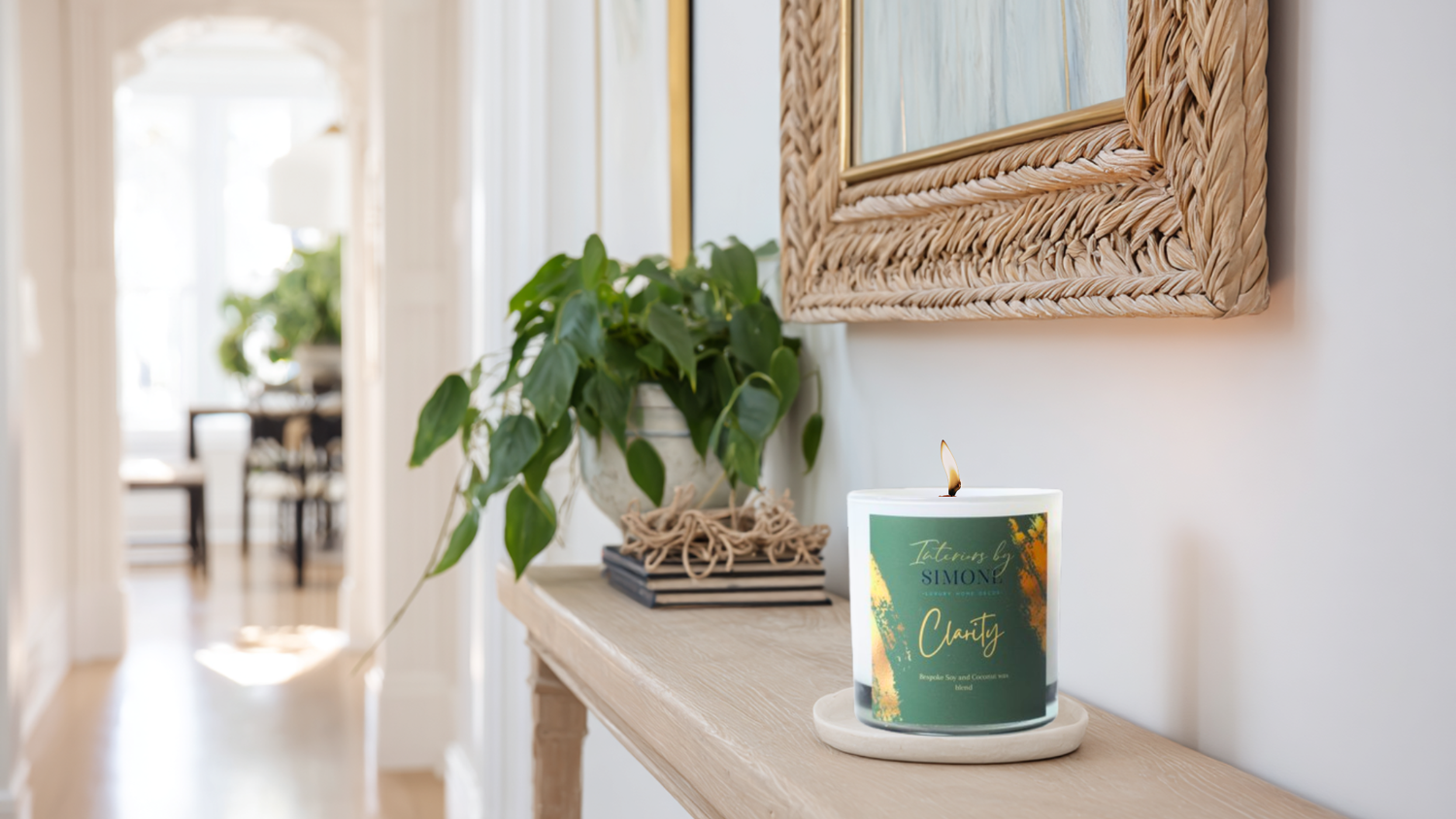 A bright entryway with a small, elegant Clarity candle on a console table